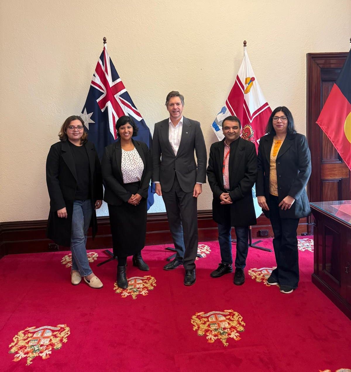 LITA representatives standing with a City of Melbourne representative at Melbourne Town Hall